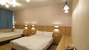 Voodi või voodid majutusasutuse Duo Yuan Hua B&B toas