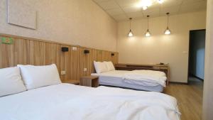 Voodi või voodid majutusasutuse Duo Yuan Hua B&B toas