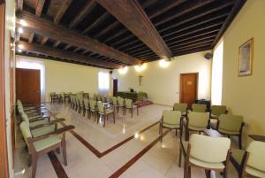 a large room with chairs and aasteryasteryasteryasteryasteryasteryasteryasteryastery at Villa Santa Maria dell'Arco - Centro Oreb in Cazzago San Martino