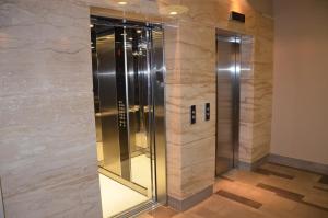 a elevator in a building with a stone wall at Apartament Żagiel in Gdańsk