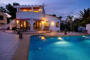 a house with a swimming pool in front of a house at Casa Calma Moraira in Moraira