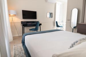 Posteľ alebo postele v izbe v ubytovaní Longo Suites