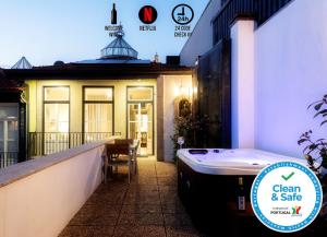 a bath tub sitting in front of a house at NorteSoul Mouzinho in Porto