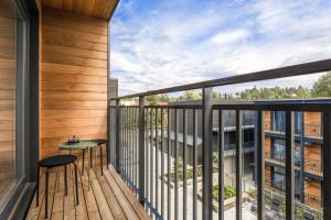 a balcony with a table and a view of a building at HOOM Home & Hotel Sollentuna in Sollentuna