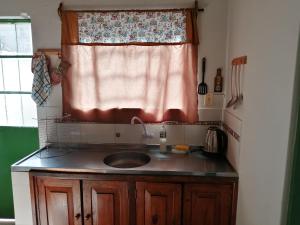 a kitchen with a sink and a window at Solar de Paz in Rivera +5 photos