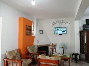 a living room with a couch and a fireplace at Solar de Paz in Rivera