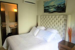 a bedroom with a bed with white sheets and pillows at 2 bedrooms luxury apartment in Playa del Carmen in Playa del Carmen +30 photos