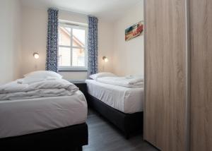 Кровать или кровати в номере Am Gerkenstrein 29-M