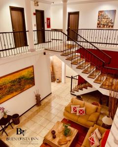 a large living room with stairs and a couch at BUENAVISTA INN in Maiquetía