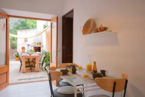 comedor con mesa de cristal y sillas en Farinera Vella en Santanyí