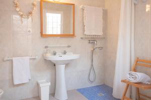 a bathroom with a sink and a shower with a mirror at Farinera Vella in Santanyi +22 photos