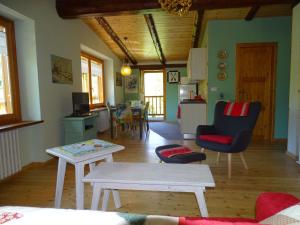 a living room with a table and a kitchen at la finestra sul Monviso in Crissolo