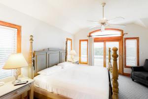 a bedroom with a bed and a chair and windows at 7 Day Weekend #33-S in Salvo +29 photos