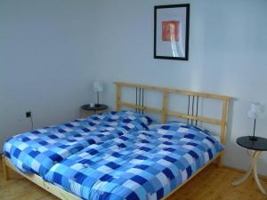 a blue and white bed in a room with two tables at Holiday Home Abertamy in Abertamy