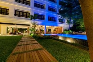 an exterior view of a building with a swimming pool at UMA Residence in Bangkok