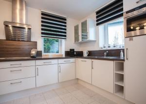 a kitchen with white cabinets and a sink at Im Hohlen Seifen 10-H in Winterberg