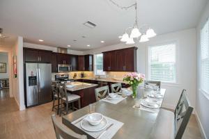 a kitchen with a table with chairs and a dining room at Lido Dream Getaway Duplex N in Sarasota