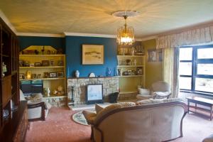 a living room with a couch and a fireplace at Anchor House Accommodation in Newport