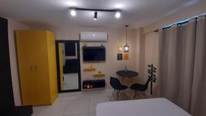 a room with a table and chairs and a yellow cabinet at BOUTIQUE FLAT ISRAEL no melhor de JAMPA in João Pessoa