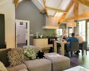 a group of people sitting at a table in a living room at Vlindervallei 8p in Ermelo
