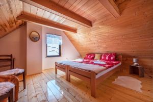 a bedroom with a bed in a wooden room at Vila Carmen kuća za odmor sa wellnessom,Sunger in Mrkopalj +99 photos
