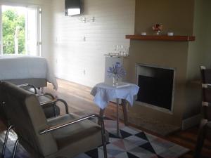 a living room with a bed and a fireplace at Pousada Toscana Cambará in Cambará