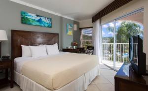 A bed or beds in a room at St. James’s Club Morgan Bay Resort - All Inclusive