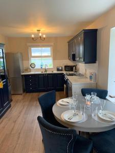 a kitchen with a table and chairs in a kitchen at Rosslare Wexford in Saint Helens