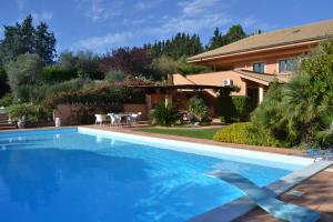 a swimming pool in front of a house at Villa Zagara Luxury Bed And Breakfast in Pescara