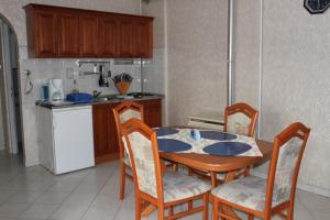 a kitchen with a table and chairs in a kitchen at Pine Wood Apartment 6 in Zalakaros