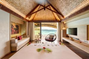 a living room with a view of the ocean at Le Bora Bora by Pearl Resorts in Bora Bora
