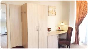 a room with a desk and a cupboard at Vivulskis Apart-Hotel in Vilnius