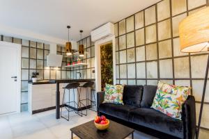 a living room with a couch and a table at Villa Capitis in the center in Hvar