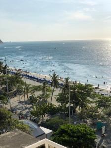 a view of a beach with people in the water at Hotel Be La Sierra in Santa Marta