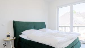 Postel nebo postele na pokoji v ubytování Apartmenthaus Wittsande Wittsande 10