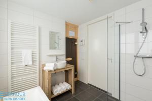 a white bathroom with a sink and a shower at Appartement - Kaapduinseweg 13 Dishoek 13D Luxe 6 personen in Dishoek +28 photos