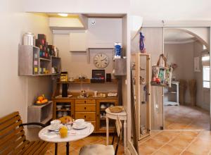 a kitchen with a table and a refrigerator at Hôtel la Bona Casa in Collioure