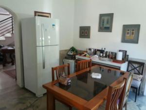 a kitchen with a table and a refrigerator at Icaro in Sao Paulo +15 photos
