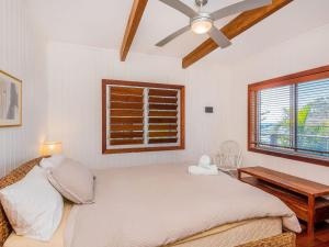a bedroom with a bed and a ceiling fan at Pacifica Unit 1 in Brooms Head