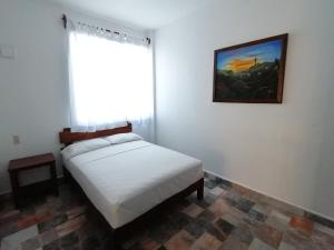 Postel nebo postele na pokoji v ubytování Don Luis Hostal - Sucursal Hidalgo - Tecolutla