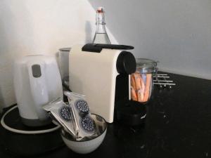 a counter top with a blender and other kitchen utensils at Studio Hugo in Nijmegen