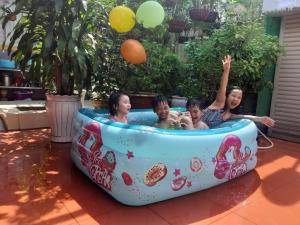 a group of people in an inflatable hot tub at Nature House Homestay in Ho Chi Minh City