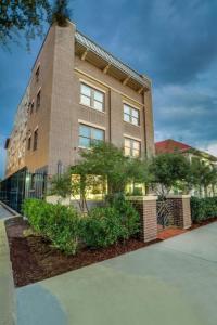 a tall brick building with bushes in front of it at Bishop Arts Hotel in Dallas