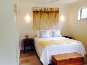 a bedroom with a white bed and a window at Putta Bucca B&B in Mudgee