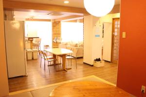 a living room and dining room with a table and chairs at K's House Tokyo - Travelers Hostel in Tokyo