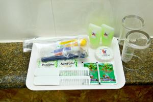 a tray with toothbrushes and other items on a counter at HOTEL KEK GRAND PARK in Chennai