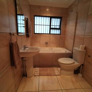 a bathroom with a tub and a toilet and a sink at The Hide on Devereux in East London