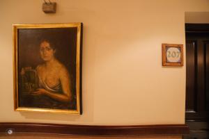 a painting of a man sitting on a wall at Hotel Posada de Vallina by MiRa in Córdoba