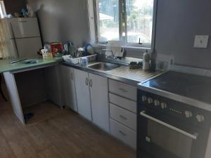 a kitchen with a sink and a counter top at Bayfair Backpack House in Tauranga