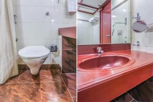 a bathroom with a red sink and a toilet at Fort Gate Hotels & Resorts in Trichūr